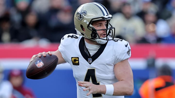 Dec 8, 2024; East Rutherford, New Jersey, USA; New Orleans Saints quarterback Derek Carr (4) drops back to pass against the New York Giants during the first quarter at MetLife Stadium. Mandatory Credit: Brad Penner-Imagn Images