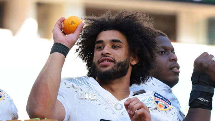 Jan 1, 2026; Miami Gardens, FL, USA; Oregon Ducks linebacker Devon Jackson (26) and quarterback Dante Moore (5) celebrate following the 2025 Orange Bowl and quarterfinal game of the College Football Playoff against the Texas Tech Red Raiders at Hard Rock Stadium. Jan 1, 2026; Miami Gardens, FL, USA; Oregon Ducks linebacker Devon Jackson (26) and quarterback Dante Moore (5) celebrate following the 2025 Orange Bowl and quarterfinal game of the College Football Playoff against the Texas Tech Red Raiders at Hard Rock Stadium.