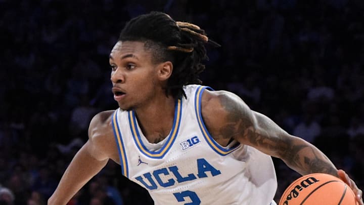 Dec 21, 2024; New York, NY, USA; UCLA Bruins guard Dylan Andrews (2) drives to the basket while being defended by North Carolina Tar Heels guard Drake Powell (9) during the first half at Madison Square Garden. Mandatory Credit: John Jones-Imagn Images