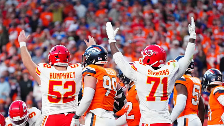 Nov 16, 2025; Denver, Colorado, USA; Kansas City Chiefs center Creed Humphrey (52) and offensive tackle Josh Simmons (71) celebrate a touchdown carry by running back Kareem Hunt (29) (center) in the third quarter against the Denver Broncos at Empower Field at Mile High. Mandatory Credit: Ron Chenoy-Imagn Images
