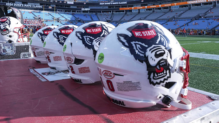 Sep 7, 2024; Charlotte, North Carolina, USA; North Carolina State Wolfpack helmets during pregame activity for the Dukes Mayo Classic against the Tennessee Volunteers at Bank of America Stadium. Mandatory Credit: Jim Dedmon-Imagn Images