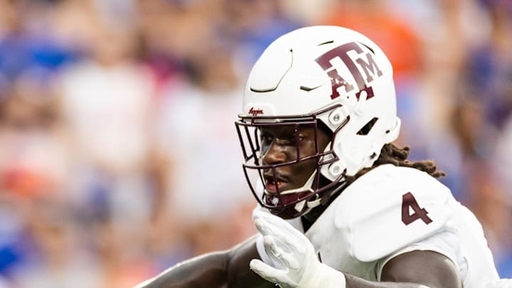 Florida Gators quarterback DJ Lagway evades Texas A&M Aggies defensive lineman Shemar Stewart. Florida Gators quarterback DJ Lagway evades Texas A&M Aggies defensive lineman Shemar Stewart.