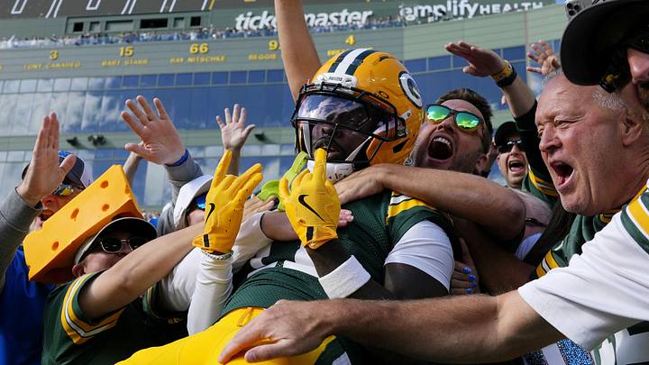 Sep 7, 2025; Green Bay, Wisconsin, USA; Green Bay Packers wide receiver Jayden Reed (11) celebrates with fans after scoring a touchdown against the Detroit Lions during the second quarter at Lambeau Field. 