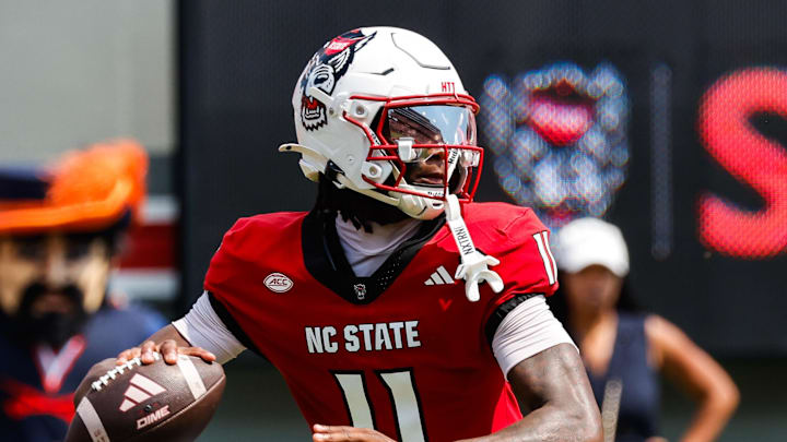 Sep 6, 2025; Raleigh, North Carolina, USA; North Carolina State Wolfpack quarterback CJ Bailey (11) prepares to throw the football during the first half of the game against Virginia Cavaliers at Carter-Finley Stadium. Mandatory Credit: Jaylynn Nash-Imagn Images