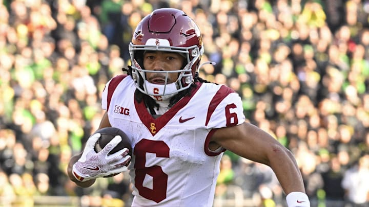 Nov 22, 2025; Eugene, Oregon, USA; Southern California Trojans wide receiver Makai Lemon (6) runs with the ball during the first half against the Oregon Ducks at Autzen Stadium. Mandatory Credit: Troy Wayrynen-Imagn Images