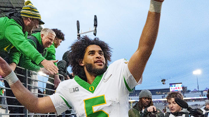 Oregon quarterback Dante Moore celebrates after the game as the Oregon Ducks take on the Washington Huskies on Nov. 29, 2025, at Husky Stadium in Seattle, Washington. Oregon quarterback Dante Moore celebrates after the game as the Oregon Ducks take on the Washington Huskies on Nov. 29, 2025, at Husky Stadium in Seattle, Washington.