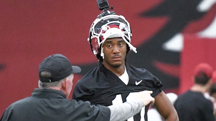 Arkansas Razorbacks quarterback listens to offensive coordinator Bobby Petrino during preseason practices at the indoor center in Fayetteville, Ark.
