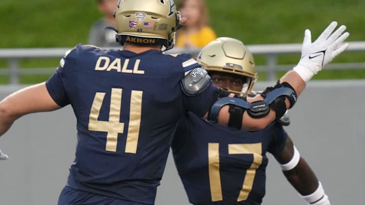 Akron defensive lineman Bruno Dall (41) congratulates defensive back Malcolm DeWalt IV (17) after a 22-yard pick-six.