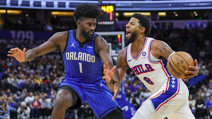Philadelphia 76ers forward Paul George (8) is fouled by Orlando Magic forward Jonathan Isaac (1) during the second quarter at Kia Center.
