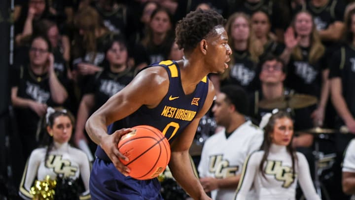 Feb 14, 2026; Orlando, Florida, USA; UCF Knights forward Devan Cambridge (35) defends West Virginia Mountaineers forward Brenen Lorient (0) during the second half at Addition Financial Arena. Mandatory Credit: Mike Watters-Imagn Images