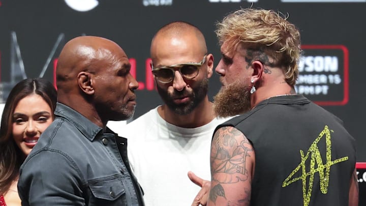 Nov 13, 2024; Irving, TX, USA;  Jake Paul (right) faces off with Mike Tyson after their press conference at The Pavilion at Toyota Music Factory. Mandatory Credit: Kevin Jairaj-Imagn Images