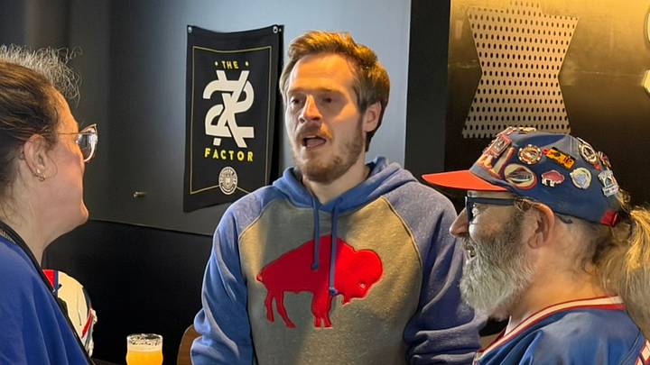 2023 NFL Fan of the Year Tom Grossi (center) speaks with two Buffalo Bills fans at his 30 in 30 Part Deux fundraiser event at Southern Tier Brewing Co. in Buffalo, N.Y. on Monday, June 22, 2026.
