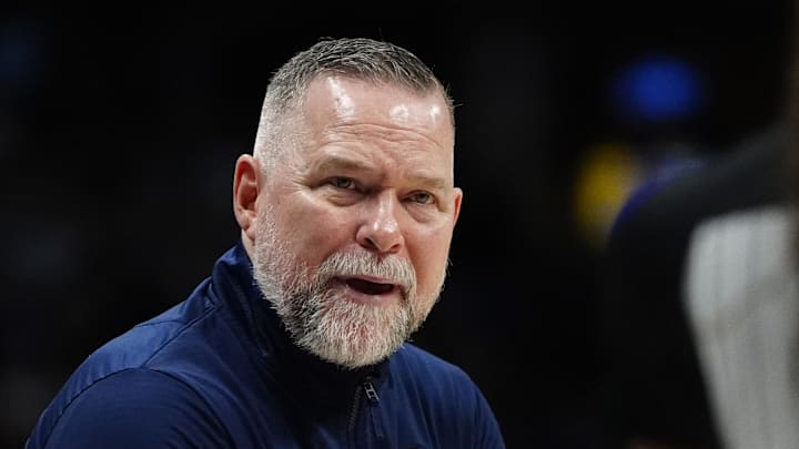 Apr 6, 2025; Denver, Colorado, USA; Denver Nuggets head coach Michael Malone reacts towards referee Danielle Scott (87) in the second half against the Indiana Pacers at Ball Arena. Mandatory Credit: Ron Chenoy-Imagn Images