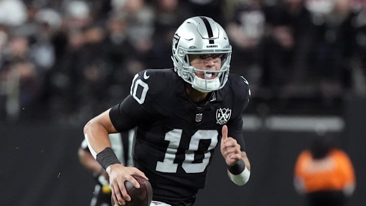 Las Vegas Raiders quarterback Desmond Ridder runs with the ball.