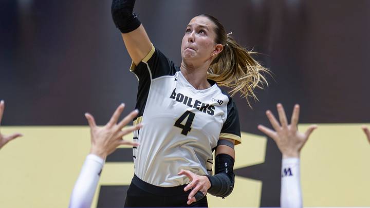 Purdue Junior Kenna Wollard (4) floats the ball over blockers. Purdue Junior Kenna Wollard (4) floats the ball over blockers.