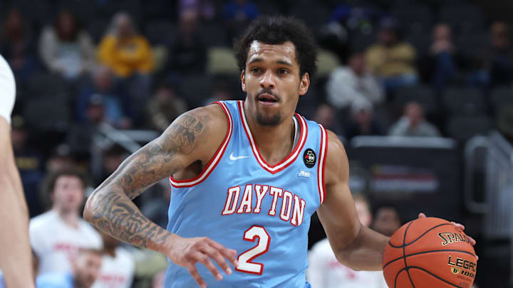 Mar 14, 2026; Pittsburgh, PA, USA;  Dayton Flyers guard De'shayne Montgomery (2) brings the ball up court against Saint Louis Billikens forward Ishan Sharma (9) during the first half in an Atlantic 10 Conference Tournament Semifinal game at PPG Paints Arena. Mandatory Credit: Charles LeClaire-Imagn Images