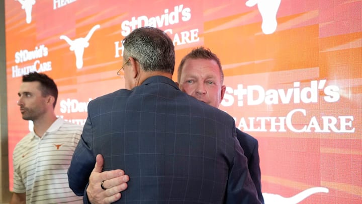 University of Texas baseball coach Jim Schlossnagle hugs Athletic Director Chris Del Conte at his introductory news conference at the Frank Denius Family University Hall of Fame Wednesday June 26, 2024.