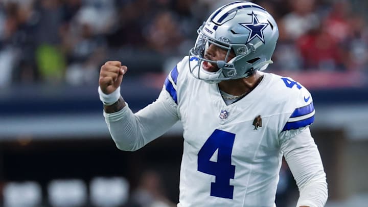 Dallas Cowboys quarterback Dak Prescott (4) reacts after throwing a touchdown pass during the first quarter against the New England Patriots at AT&T Stadium.