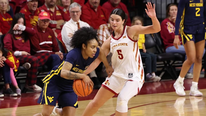 Jan 11, 2026; Ames, Iowa, USA; Iowa State Cyclones guard Evangelia Paulk (5) defends West Virginia Mountaineers guard Sydney Shaw (5) during the second half at James H. Hilton Coliseum. Mandatory Credit: Reese Strickland-Imagn Images