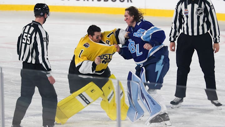 Feb 1, 2026; Tampa Bay, Florida, USA; Boston Bruins goaltender Jeremy Swayman (1) and Tampa Bay Lightning goaltender Andrei Vasilevskiy (88) exchange punches as officials Kyle Flemington and Julien Fournier look on during the second period in the 2026 Stadium Series ice hockey game at Raymond James Stadium. Mandatory Credit: Nathan Ray Seebeck-Imagn Images