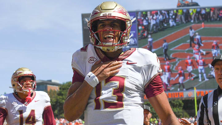 Sep 23, 2023; Clemson, South Carolina, USA; Florida State Seminoles quarterback Jordan Travis (13) reacts after scoring against the Clemson Tigers during the second quarter at Memorial Stadium. Mandatory Credit: Ken Ruinard-Imagn Images