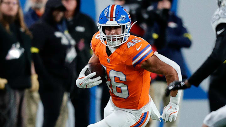 Nov 6, 2025; Denver, Colorado, USA; Denver Broncos fullback Adam Prentice (46) runs the ball against Las Vegas Raiders cornerback Eric Stokes (22) in the third quarter at Empower Field at Mile High. 