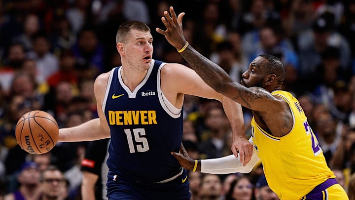 Apr 29, 2024; Denver, Colorado, USA; Denver Nuggets center Nikola Jokic (15) controls the ball under pressure from Los Angeles Lakers forward LeBron James (23) in the first quarter during game five of the first round for the 2024 NBA playoffs at Ball Arena. Mandatory Credit: Isaiah J. Downing-Imagn Images