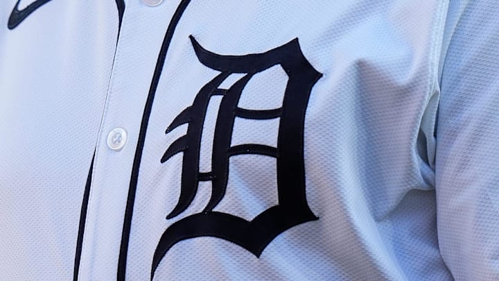 The Gothic D Detroit Tigers logo on the front of a white jersey during a home game. 