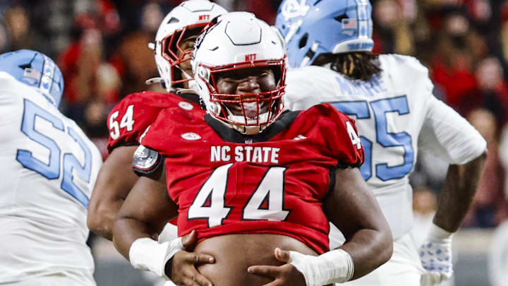 Nov 29, 2025; Raleigh, North Carolina, USA;  NC State Wolfpack defensive tackle Brandon Cleveland (44) reacts to his tackle during the first half of the game against the North Carolina Tar Heels at Carter-Finley Stadium.  Mandatory Credit: Jaylynn Nash-Imagn Images