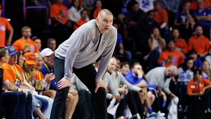 Feb 14, 2026; Gainesville, Florida, USA; Kentucky Wildcats head coach Mark Pope looks on while Florida Gators head coach Todd Golden stands on the sideline during the second half at Exactech Arena at the Stephen C. O'Connell Center. Mandatory Credit: Matt Pendleton-Imagn Images