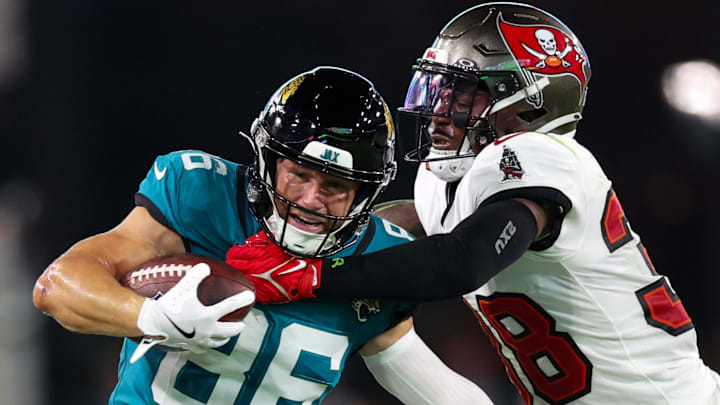 Jacksonville Jaguars wide receiver Austin Trammell (86) fights off Tampa Bay Buccaneers safety Rashad Wisdom (38) 