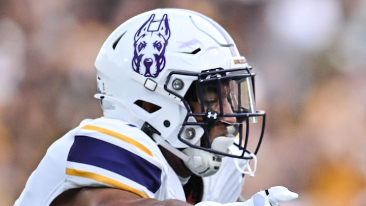 Aug 30, 2025; Iowa City, Iowa, USA; Iowa Hawkeyes running back Kamari Moulton (28) runs the ball as Albany Great Danes defensive back Cam Stodghill (1) and defensive back Denzel Patrick (2) make the tackle during the first quarter at Kinnick Stadium. Mandatory Credit: Jeffrey Becker-Imagn Images