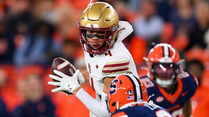 Nov 29, 2025; Syracuse, New York, USA; Boston College Eagles wide receiver Reed Harris (4) runs with the ball after a catch in front of Syracuse Orange defensive back Braheem Long Jr. (0) during the first half at the JMA Wireless Dome. Mandatory Credit: Rich Barnes-Imagn Images