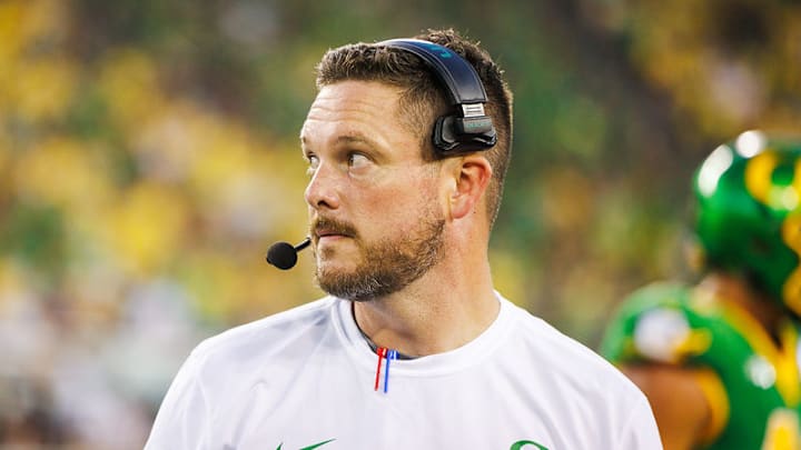 Oregon coach dan lanning ducks dante moore iowa hawkeyes kinnick stadium wave hostile fans playoff upset big ten road game schedule