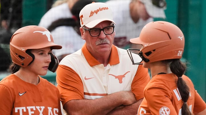 Texas Longhorns head coach Mike White talks to players Leighann Goode and Jaycie Nichols during a time out at Rhoads Stadium.