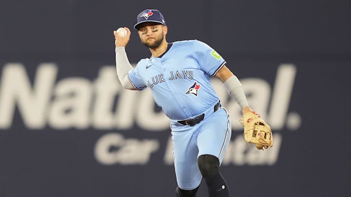 Mar 30, 2025; Toronto, Ontario, CAN; Toronto Blue Jays shortstop Bo Bichette (11) goes to throw out Baltimore Orioles first baseman Ryan Mountcastle (not pictured) during the sixth inning at Rogers Centre.