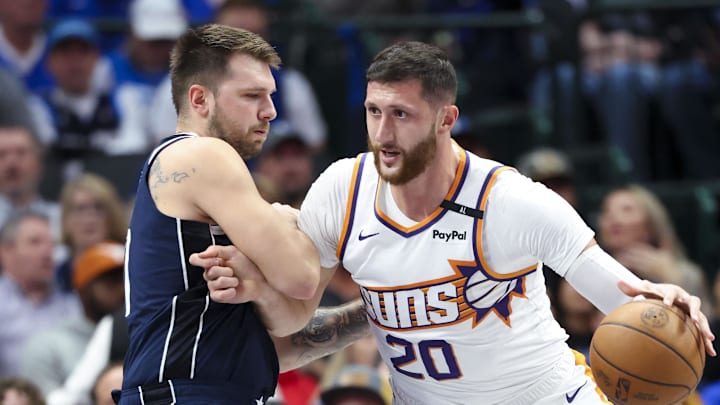 Nov 8, 2024; Dallas, Texas, USA;  Phoenix Suns center Jusuf Nurkic (20) dribbles as Dallas Mavericks guard Luka Doncic (77) defends during the first quarter at American Airlines Center. Mandatory Credit: Kevin Jairaj-Imagn Images