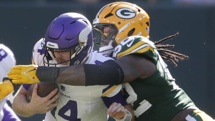 Green Bay Packers defensive end Rashan Gary (52) sacks Minnesota Vikings quarterback Sam Darnold in 2024.