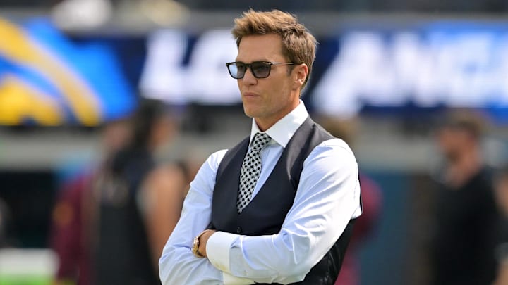Tom Brady looks on before the game between the Los Angeles Chargers and the Washington Commanders.