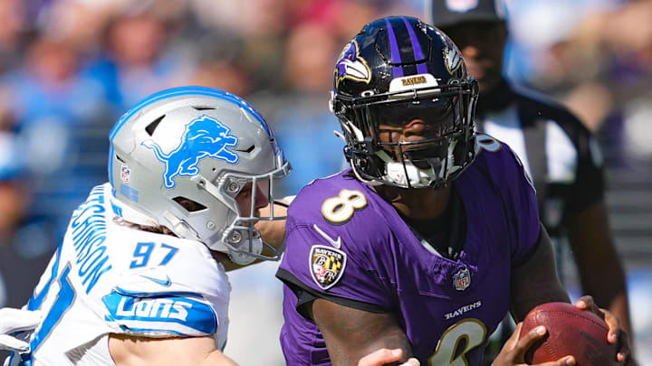 Baltimore Ravens quarterback Lamar Jackson (8) is tackled by Detroit Lions defensive lineman Aidan Hutchinson (97).