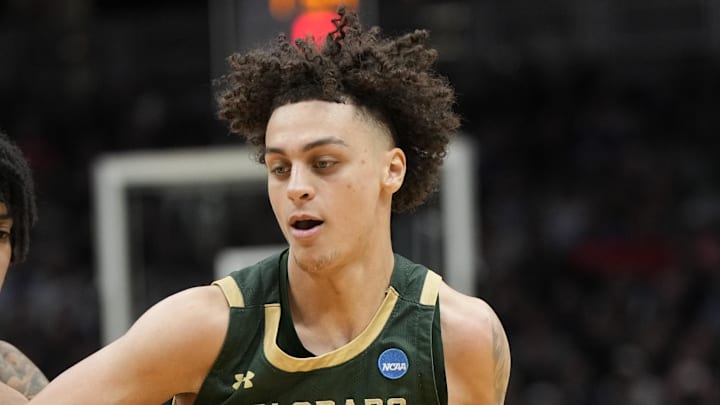 Mar 21, 2025; Seattle, WA, USA; Colorado State Rams guard Kyan Evans (0) drives the ball past Memphis Tigers guard PJ Haggerty (4) during the second half at Climate Pledge Arena. 