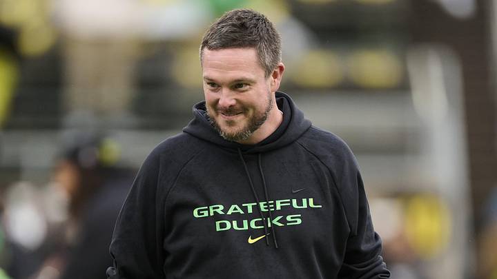 Oct 25, 2025; Eugene, Oregon, USA; Oregon Ducks head coach Dan Lanning encourages players during warm ups before a game against the Wisconsin Badgers at Autzen Stadium. The Ducks are wearing uniforms celebrating the Grateful Dead. Mandatory Credit: Troy Wayrynen-Imagn Images