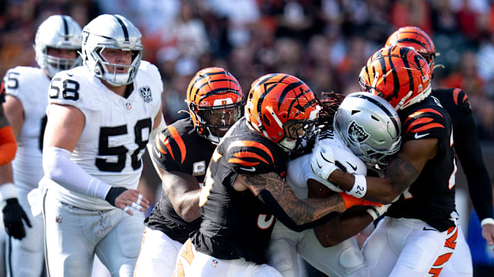 Cincinnati Bengals linebacker Logan Wilson (55) and Cincinnati Bengals cornerback Mike Hilton (21) tackle Las Vegas Raiders cornerback Decamerion Richardson (25) in the second quarter of the NFL game at Paycor Stadium in Cincinnati on Sunday, Nov. 3, 2024.
