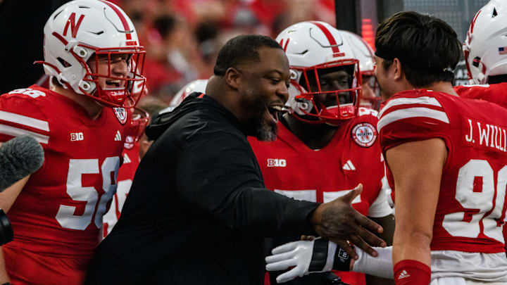 James Williams celebrates the Nebraska defense's final stop of the 2024 game against Rutgers with defensive line  coach Terrance Knighton.   