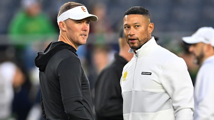 Oct 14, 2023; South Bend, Indiana, USA; USC Trojans head coach Lincoln Riley and Notre Dame Fighting Irish head coach Marcus Freeman chat before the game at Notre Dame Stadium. Mandatory Credit: Matt Cashore-Imagn Images