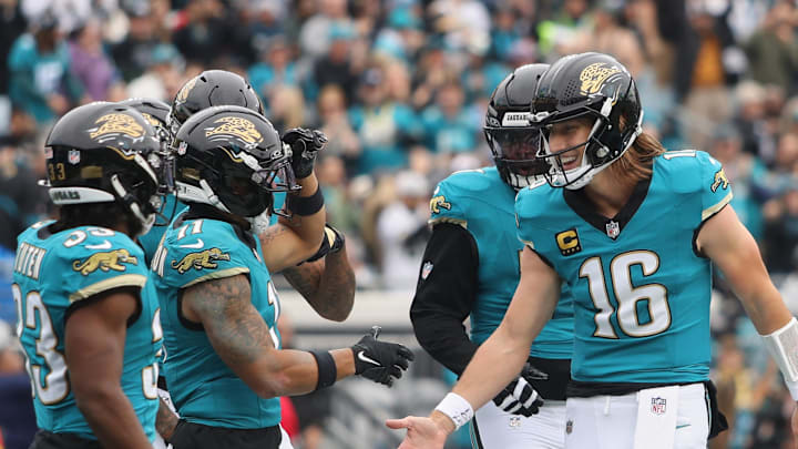 Jan 4, 2026; Jacksonville, Florida, USA; Jacksonville Jaguars wide receiver Parker Washington (11) celebrates with quarterback Trevor Lawrence (16) after scoring a touchdown against the Tennessee Titans during the first quarter at EverBank Stadium. Mandatory Credit: Morgan Tencza-Imagn Images
