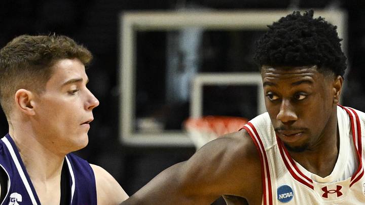 Mar 19, 2026; Portland, OR, USA; Wisconsin Badgers guard John Blackwell (25) drives against High Point Panthers guard Conrad Martinez (9) during the second half of a first round game of the men's 2026 NCAA Tournament at Moda Center. Mandatory Credit: Troy Wayrynen-Imagn Images