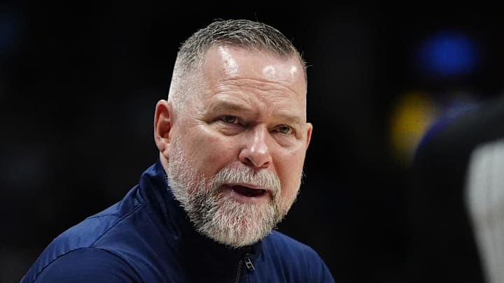 Apr 6, 2025; Denver, Colorado, USA; Denver Nuggets head coach Michael Malone reacts towards referee Danielle Scott (87) in the second half against the Indiana Pacers at Ball Arena. Mandatory Credit: Ron Chenoy-Imagn Images