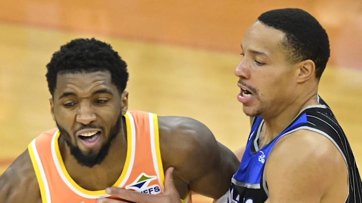 Cleveland Cavaliers guard Donovan Mitchell dribbles beside Orlando Magic guard Desmond Bane.