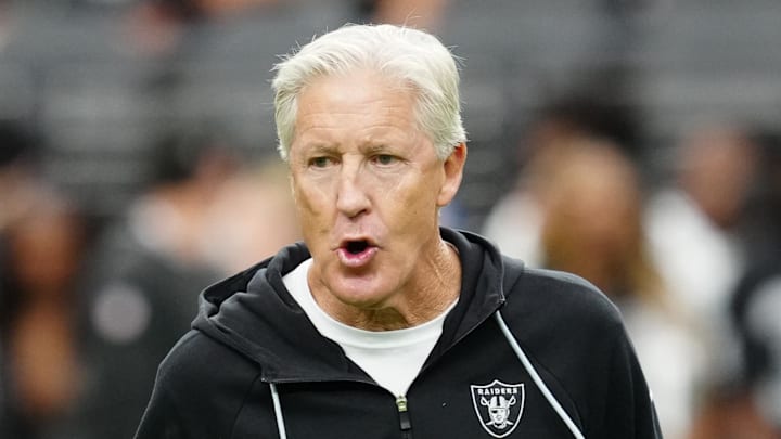 Sep 28, 2025; Paradise, Nevada, USA; Las Vegas Raiders head coach Pete Carroll communicates with safety Chris Smith II (29) during warm ups prior to the game against the Chicago Bears at Allegiant Stadium. Mandatory Credit: Stephen R. Sylvanie-Imagn Images